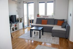 a living room with a couch and a table at Apartman 442 in Vrnjačka Banja