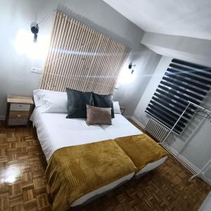 a bedroom with a large bed with a large window at Luxury Family Homes M in Salamanca