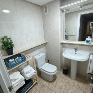 a bathroom with a white toilet and a sink at Luxury Family Homes M in Salamanca