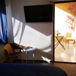 a living room with a television and a table with oranges on it at Sunny studio La Mata beach in Torrevieja