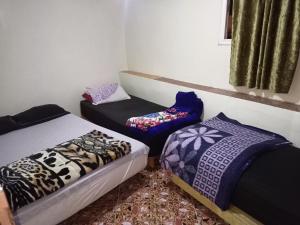 una camera con due letti e un divano in esso di Booking and hosting medina a Casablanca