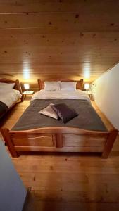 a bedroom with a large bed in a log cabin at Apartment 533 at Aparthotel Vucko Jahorina in Jahorina