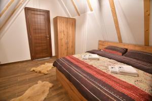a bedroom with a bed and a wooden floor at Brvnara Mont in Zlatibor