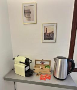 a counter with a toaster and a tea pot on it at Studio confort Vanves Paris Porte de Versailles in Vanves