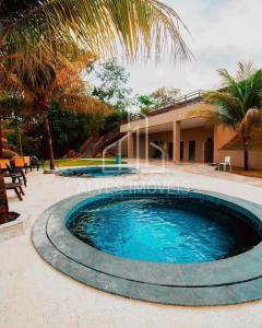 a swimming pool in front of a house at Lindo Apartamento no Aldeia do Lago em Caldas Novas in Caldas Novas