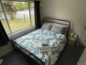 a bedroom with a bed with towels on it at Comfortable 2-Bedroom home in Mudgee - Rest Easy Mudgee in Mudgee