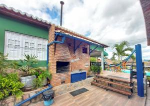 a brick house with a deck and a patio at Lindo Privê 04 Suítes com AR, 5WC e Grande Piscina in Gravatá