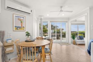 a dining room and living room with a table and chairs at Bayview Cottage in Ventnor