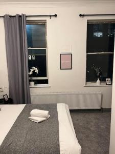 a bedroom with a bed with two towels on it at 1 bedroom flat in Kings cross! London in London