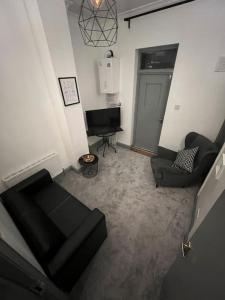 a living room with a couch and a television at 1 bedroom flat in Kings cross! London in London