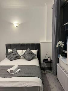 a bedroom with a bed with a phone on it at 1 bedroom flat in Kings cross! London in London