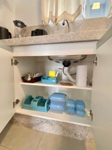 a kitchen pantry with a sink and some dishes at Recanto da Natureza & SPA in Penha