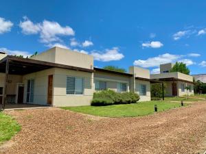 a house with a gravel driveway in front of it at Aloha in Colón