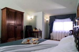 Katil atau katil-katil dalam bilik di Dominus Hotel