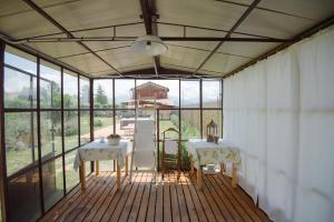 a dining room with two tables and a large window at Dolce Sosta in Lucca