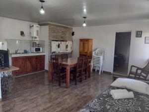 a kitchen and dining room with a table and chairs at ESPACIO CANELA in Ramallo