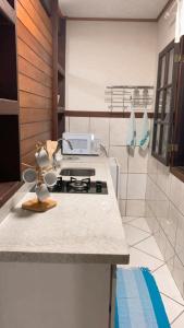 a kitchen with a stove top on a counter at Recanto do Sol in Praia de Araçatiba