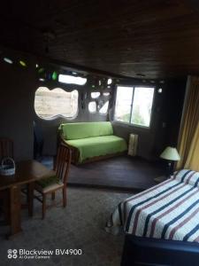 Zimmer mit 2 Betten, einem Tisch und einem Sofa in der Unterkunft Casita entre dunas al son del mar in Salinas