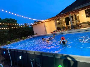 a group of people in a swimming pool at night at Villa Ruby - with private swimming pool in Kota Bharu
