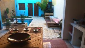 a patio with a wooden table and a pool at La Choza Guesthouse in Santo Domingo