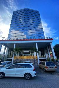 a car parked in front of a building at Travellers Hotel Phinisi in Makassar