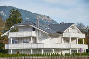 ein großes weißes Haus mit schwarzem Dach in der Unterkunft Cara in Garmisch-Partenkirchen
