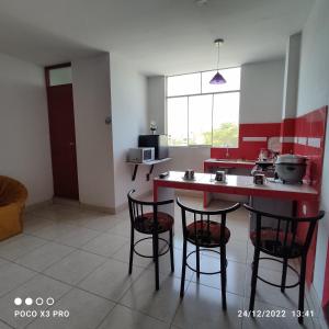 a kitchen with a table and chairs in a room at Departamento-Natural M4 in Chiclayo