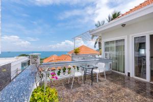 ein Balkon mit Tisch und Stühlen und dem Meer in der Unterkunft Rio TD5 homestay in Vũng Tàu