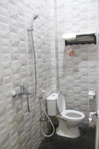 a bathroom with a shower with a toilet in it at Bu Sepuh GuestHouse in Sangkanurip +30 photos