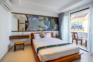 a bedroom with a bed and a large window at The Present River Villa Hoi An in Hoi An