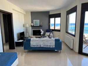 a bedroom with a blue bed and a fireplace at Magical Seaside Town Boutique Apts 2 in Kyparissia