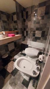 a bathroom with a white toilet and a shower at Departamento en Microcentro (Obelisco) in Buenos Aires +32 photos