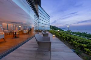 a balcony of a building with tables and chairs at KAMENOI HOTEL Ako in Ako