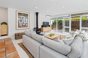 a living room with a couch and a fireplace at Seaspray in Sorrento