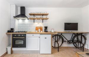 a kitchen with a bike on a counter with a stove at Beautiful Home In Crikvenica With Kitchen in Crikvenica