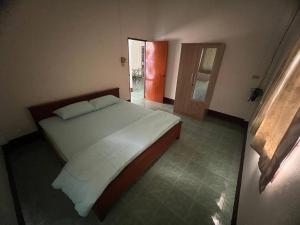 a bedroom with a white bed and a door at Kata Vl2_Superior in Ban Karon