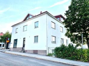 a white building on the side of a street at 80m2 Central Lahti Apartment @Karjalankatu in Lahti