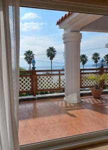 a view of the ocean from the balcony of a house at Good Day Pension in Seogwipo