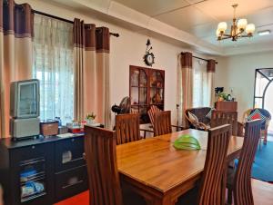 a kitchen and dining room with a wooden table and chairs at KPL Holiday Homes in Hatton