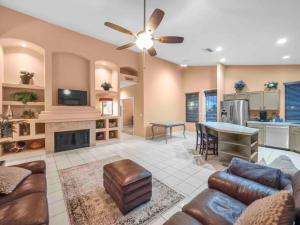 a large living room with a ceiling fan and a kitchen at Private house in N Scottsdale in Cave Creek