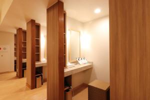 a bathroom with a sink and a mirror at Hotel Ichii in Kusatsu