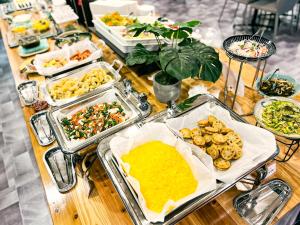 a table with many trays of food on it at Hotel Abest Naha Kokusaidori in Naha