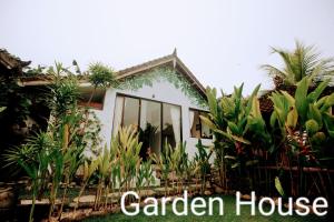 a garden house with plants in front of it at Ayumar Homestay Medewi in Pulukan