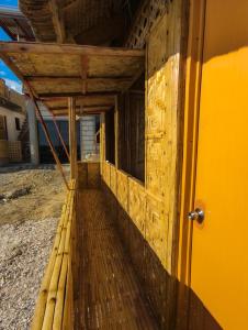 an outside view of a building with a wooden porch at Truth be Found Ministry Resort in Jagna