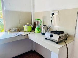 a counter with a blender and a toaster on it at Hamba Hostel for Safari in Hambantota