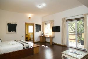 a bedroom with a bed and a large window at Superior Room Space Available in Accra