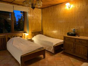 a bedroom with two beds and a window in it at Pokoje Kaja in Jeleniewo