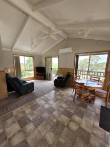 a living room with a table and chairs at Mollymook Caravan Park in Mollymook
