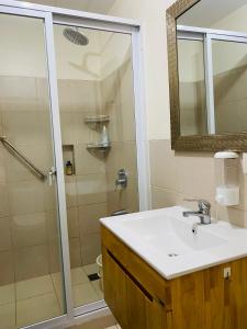a bathroom with a sink and a shower at Condo Suite Near JohnHay MinesView TheMansion in Baguio