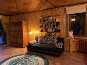 a living room with a couch and a book shelf at Pokoje Kaja in Jeleniewo